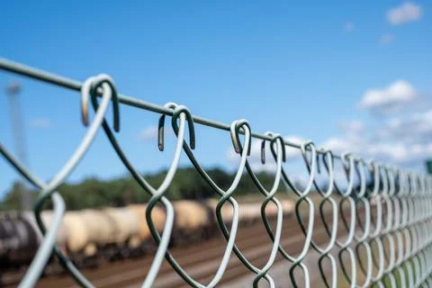 A wire fence separates the freight train. Copy space Stock Photos