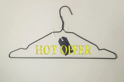 Wire hanger with bold text displaying hot offer and a price tag attached for Stock Photos