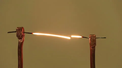 Wire melts from flowing of electric current. Electrical filament. Fuse. Video stock 41837333