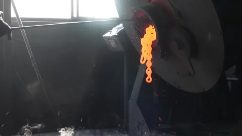 Wire mesh basket loaded with metal parts is emptied by a worker into a factory Видео 339123176