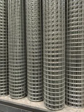 Wire mesh with steel structure rolled into bundles and offered in a modern .. Stock Photos