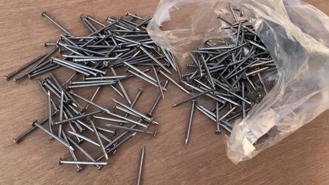 Wire Nails Scattered on a Table for Construction and Carpentry Use Stock-Footage 324008611