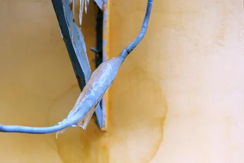 The wire in the plastic shield is covered with a layer of ice Stock Photos