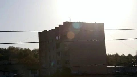 Wire power lines in the rays of the setting sun on the background of buildings Stock Footage 92632256