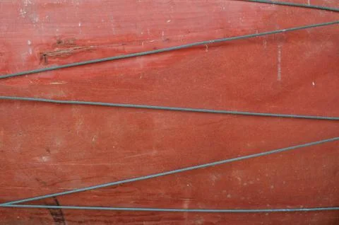 Wire on red wood background Stock Photos