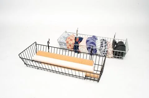 Wire Storage Baskets with Rolled Fabrics on White Background Stock Photos