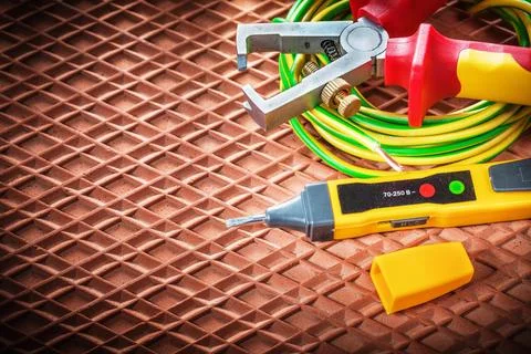 Wire stripper electric cable tester on dielectric mat Stock Photos