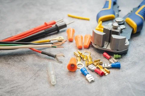 Wire strippers or cable strippers tool and Solderless Terminals on desk. El.. Stock Photos