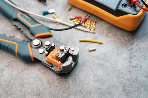 Wire strippers or cable strippers tool on desk. Electrical tools concept Stock Photos