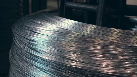 The wire is wound on a large spool at the factory Stock-Footage 171112372