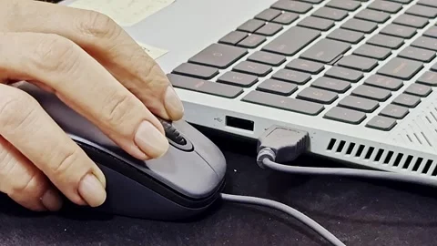 Wired and steady, a task in hand, guiding the mouse with firm command Stock Footage 303562603