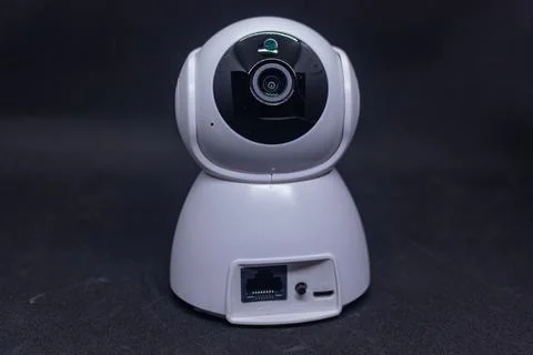 Wired CCTV camera system on black backdrop Foto stock