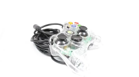 Wired game controller rotating on white background Stock Footage 40413881