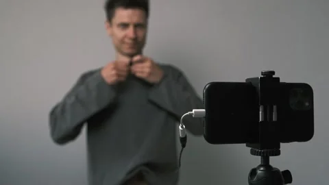 Wired lapel mic struggles in modern video blogging setup. Shot highlights Stock Footage 311643276