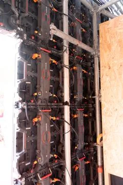 Wired LED wall modules with scaffolding and plywood panel 스톡 사진