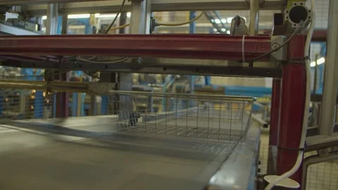 Wired mesh cages moving on the track in the factory Stock Footage 152774008