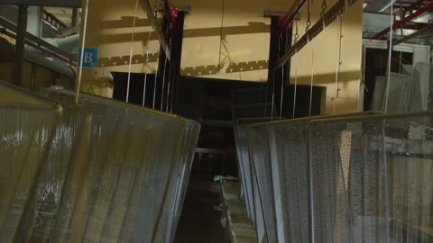 Wired mesh cages moving on the track in the factory Stock Footage 153468640