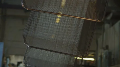 Wired mesh cages moving on the track in the factory Stock Footage 153469428