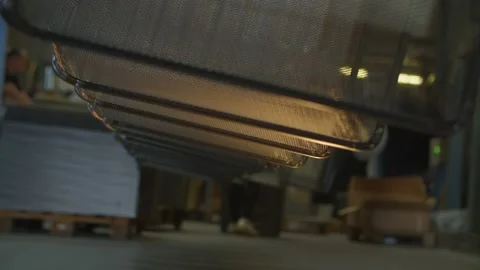 Wired mesh cages moving on the track in the factory Stock Footage 153469470