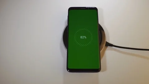 Wired vs wireless mobile phone charging with green screen locked and unlocked. Stock Footage 95906348