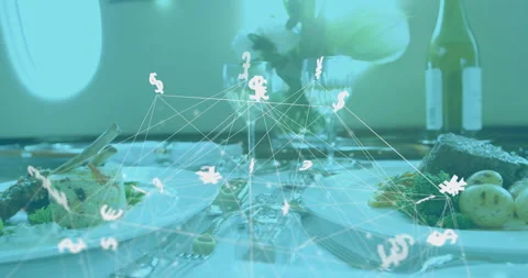 Wireframe forming above plate initiating currency symbols floating across twin Video stock 315716125