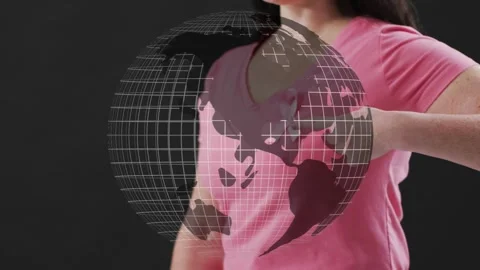 Wireframe globe appearing over torso causing woman pointing, holding near pink Stock Footage 335255345