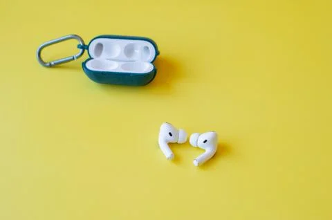 Wireless Bluetooth Earphone or Earbud or Headphone, Isolated on yellow backgr Stock Photos