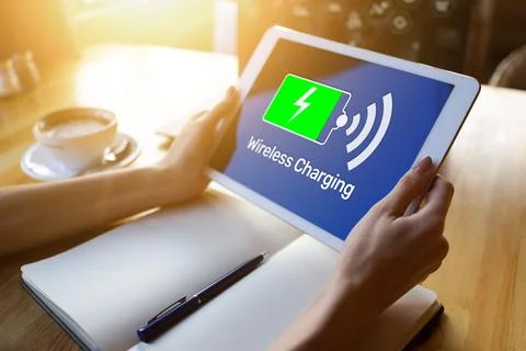 Wireless charging icons and progress bar on device screen Фото