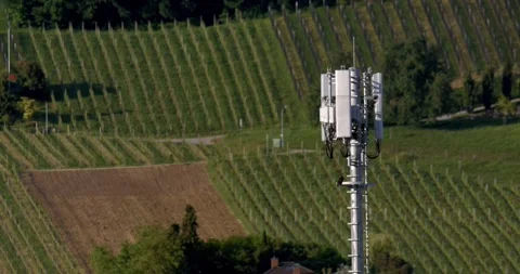 Wireless Communication Equipment Situated Over Lush Agricultural Fields With Exp Stock Footage 335579161
