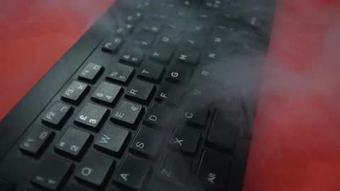 Wireless computer keyboard and steam clouds on red closeup Видео 136426394