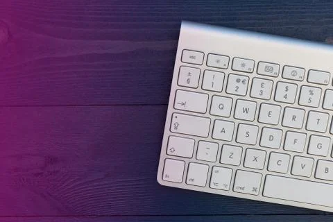 Wireless computer keyboard on night office desk with copy space Stock Photos