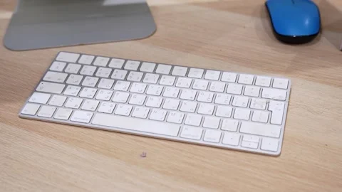 Wireless Computer Keyboard on Wooden Desk in Modern Office Workspace Видео 332810701