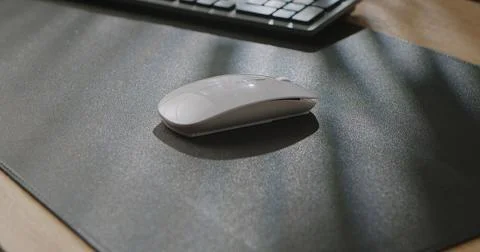 Wireless Computer Mouse on Dark Surface in Sunlight Stock Photos