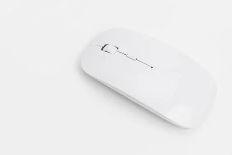 Wireless computer mouse on a flat surface showing simple design Stock Photos