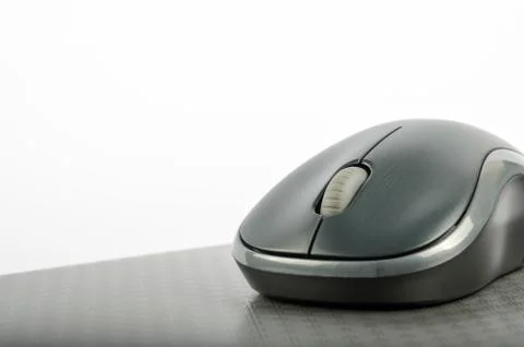 Wireless computer mouse on a metallic background Stock Photos