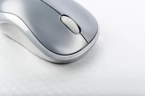 Wireless computer mouse on a metallic background Stock Photos