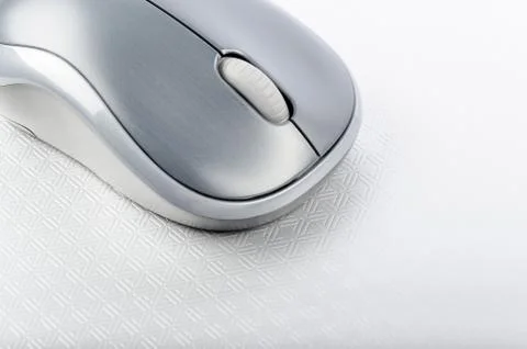 Wireless computer mouse on a metallic background Stock Photos