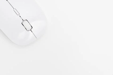 Wireless computer mouse on a white surface beside a keyboard Stock Photos