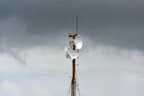 Wireless data station aerial view Against a cloudy sky. Cell tower Stock Photos