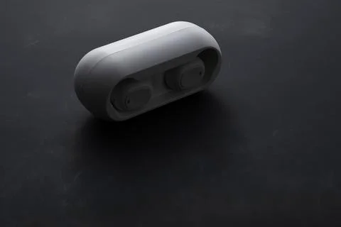 Wireless earbuds case on dark background technology product photo Stock Photos