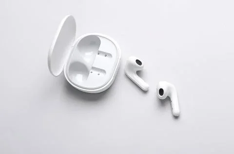 Wireless earbuds with charging case on white background Stock Photos