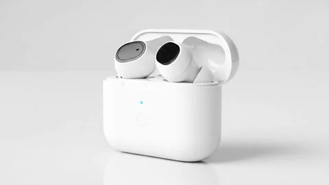 Wireless earbuds in white case on white surface with light gray background Stock Footage 331239797