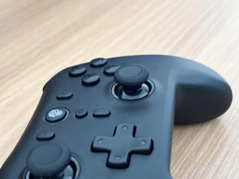 Wireless Game Controller on Wooden Background Professional Gaming Joystick Stock Photos