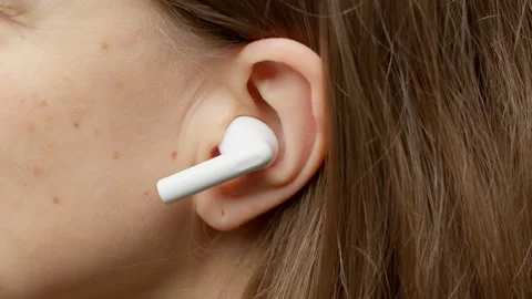 Wireless headphones are inserted into the ear, close-up. Stock Footage 264964435