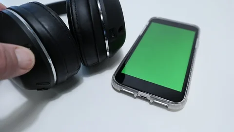 Wireless Headphones Connecting to Greenscreen iPhone 動画素材 127727092