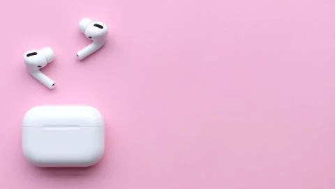 Wireless headphones on a pink background, space for text Stock Photos