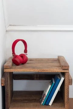 Wireless headset on rustic nightstand Stock Photos