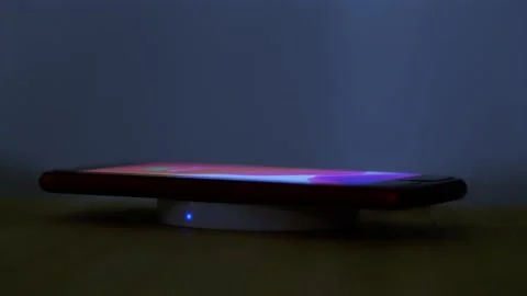 Wireless induction charger base for mobile phone. Stock Footage 139508511