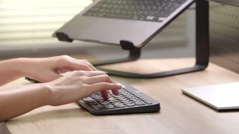 Wireless keyboard and smartphone, hands typing in home office. Stock Footage 316657145