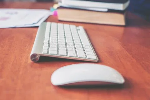 Wireless keyboard, mouse on the wood table of business person. Stock Photos